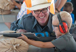 New Mexico Game & Fish officer instructs youth during a shooting sports program at Outdoor Expo.