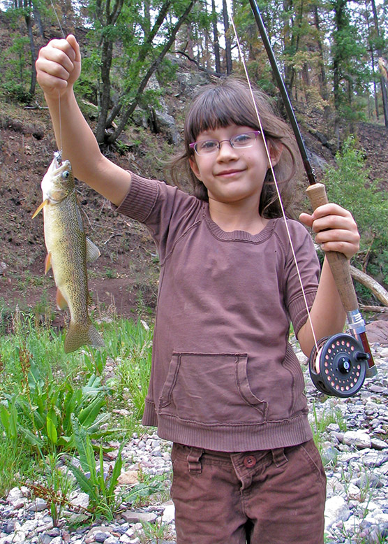 Willow Springer hefts a Gila trout in Black Canyon (photo Graig Springer) - New Mexico Game and Fish
