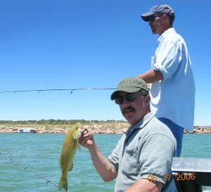 Angler with nice sized smallmouth bass from Conchas Lake - (New Mexico Game and Fish).